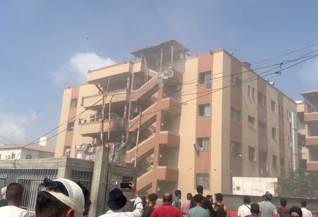 People walk at the site of Israeli strikes on Nasser hospital in Khan Younis, Gaza on Monday. Photo: Reuters