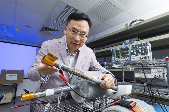 The golden sheet held by Dr Tse is a sensor that, when wrapped around exposed parts of a pipe, identifies corrosion in parts of a pipe that are covered.