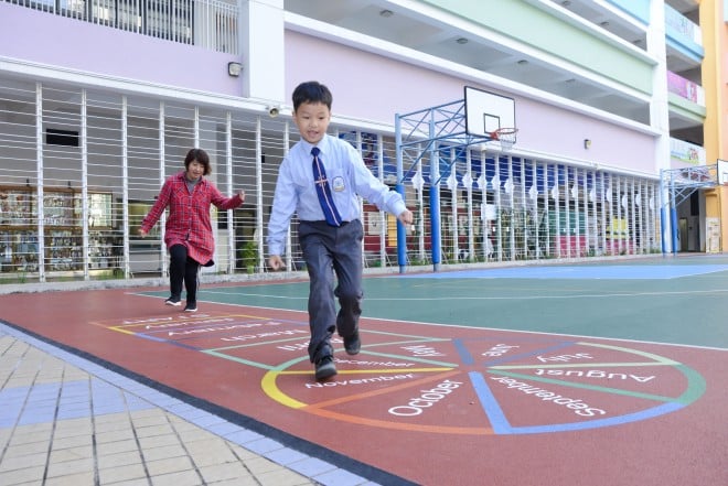 Wong Tsz-fung (right), a primary one student, has become more independent and disciplined and has learnt to think more positively since joining Fun to Move@JC.