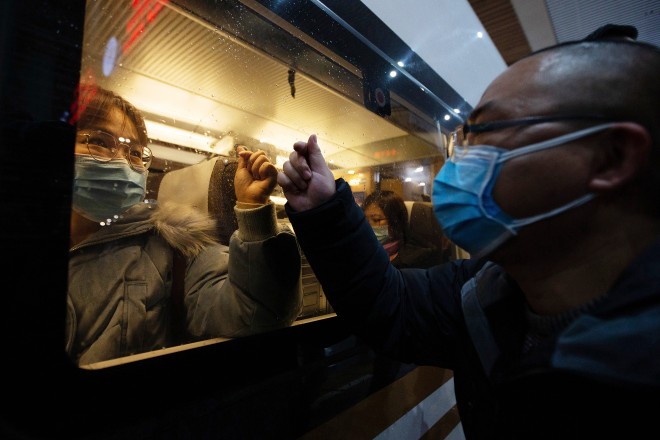 A person bids farewell to a medical worker who was heading to Wuhan at the train station in the eastern city of Nanjing on January 25.