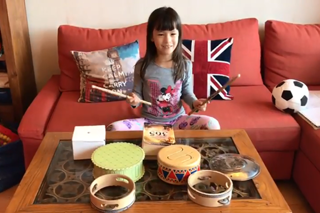 A Primary Year 2 student enjoys producing a series of rhymed percussion with various inverted vessels.