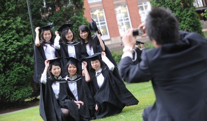 Overseas students pose for a photo on graduation day at Birmingham University, UK.