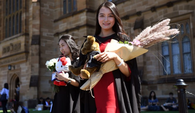 A Chinese student poses at graduation from Sydney University.