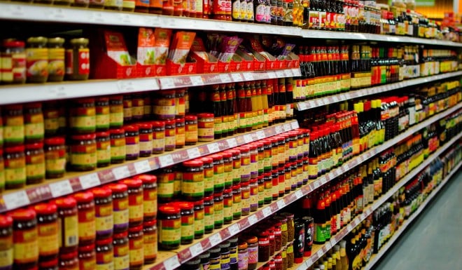 Condiment jars on the shelves of an Asian grocery store.