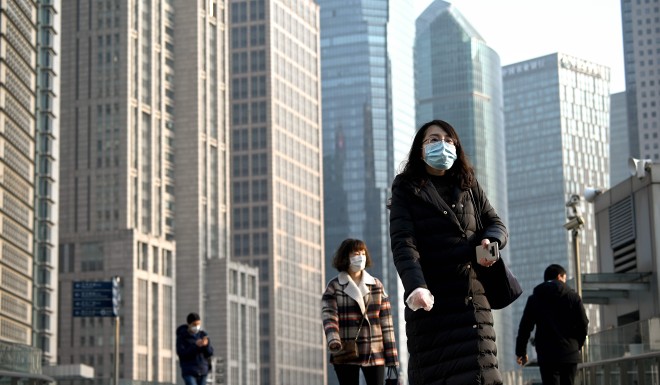 People wear protective facemasks in Shanghai. While the virus did spread across China, it was not as devastating as in Hubei province.