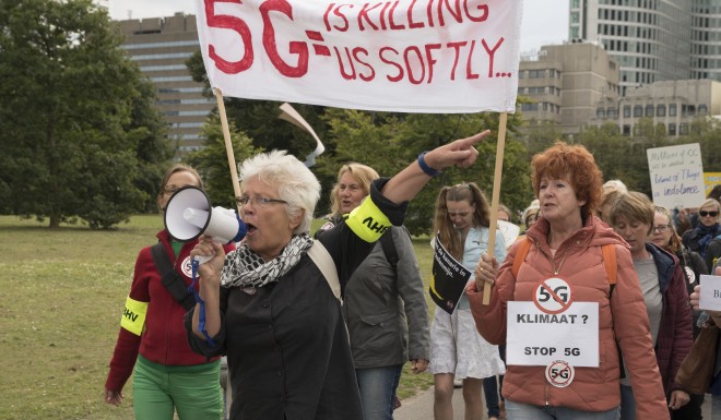 Protesters march against 5G technology in The Hague, Netherlands. They are worried about possible side effects from prolonged exposure to high frequency radio waves. Photo: Michel Porro/Getty Images