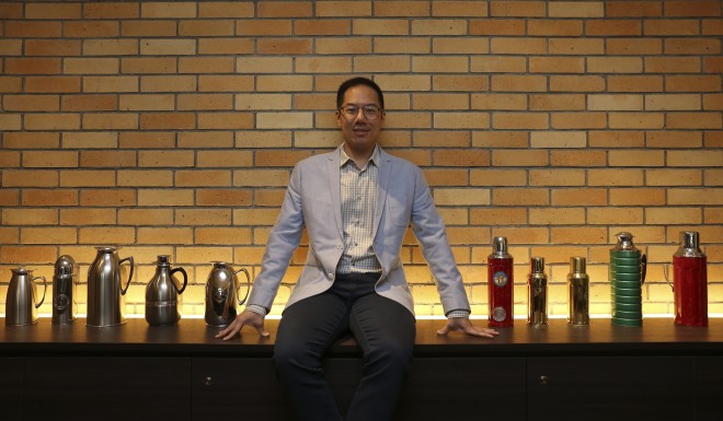 Raymond Leung with a display of Camel vacuum flasks at the Camlux Hotel, opened in the former flask factory. Photo: Jonathan Wong