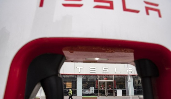 The Tesla Inc. logo is displayed on an electric vehicle charging station outside one of the companys showrooms in Beijing China, on Saturday, March 6, 2021. China, the worlds biggest car market, aims to boost auto sales and add more charging facilities for electric vehicles this year. Photographer: Qilai Shen/Bloomberg