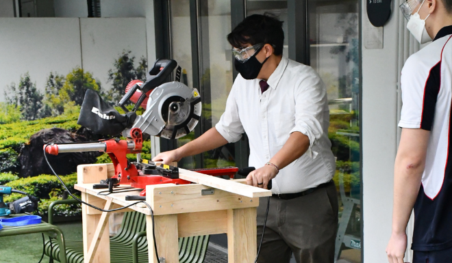 In the Design Technology workshop, Mr. Nichols helps Grade 10 students develop skills in modeling and construction.