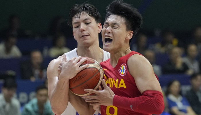 Philippines center June Mar Fajardo (15) against China center Zhou Qi (15)  during their Basketball World