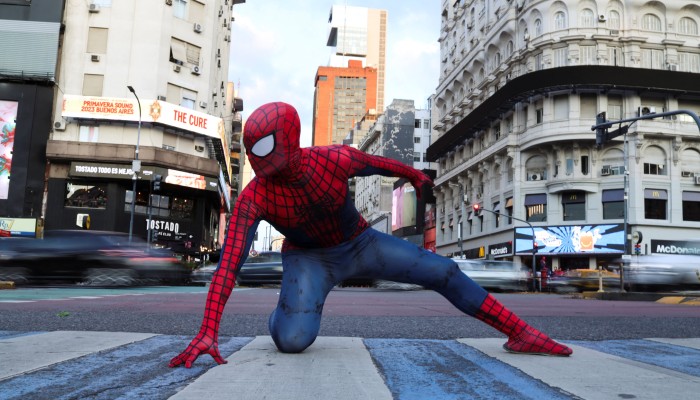 Download Spider Man Trilogy Posing Infront Billboard Wallpaper |  Wallpapers.com