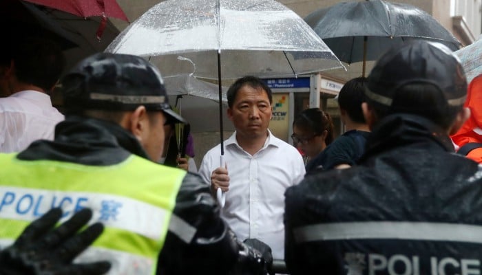 Ex-Hong Kong opposition leader Wu Chi-wai enters UK under temporary admission after reported denial; deportation threat remains pending