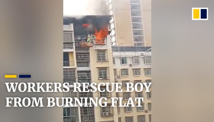 Construction workers use crane to rescue boy from burning flat in China ...