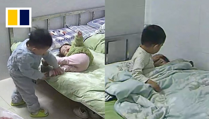 Boy puts little sister to sleep while mother is at work | South China Morning Post