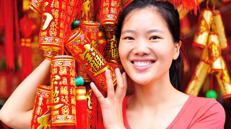 A woman holds Lunar New Year decorations. Throughout China, greetings in various dialects will be exchanged to welcome the Year of the Horse. Here are some of them and their meanings. Photo: Shutterstock