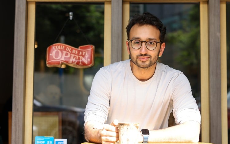 Ali Abdaal, a former doctor who is now a digital creator, entrepreneur and YouTube star, sits at a cafe in Causeway Bay. Abdaal will speak at the Hong Kong Jockey Club Amphitheatre on December 8 to explain how to make 2026 “the best year of your life”. Photo: Nora Tam