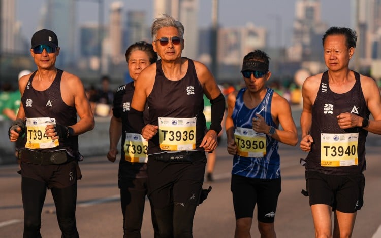 Actor Chow Yun-fat (middle) runs in the 10km event at the Standard Chartered Hong Kong Marathon 2026. The 70-year-old is part of a growing number of older people competing in endurance races. Photo: Eugene Lee