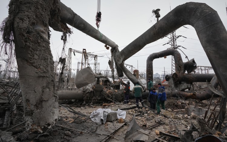 Workers clean up the Darnytsia Thermal Power Plant after a Russian attack in Kyiv. Photo: AP