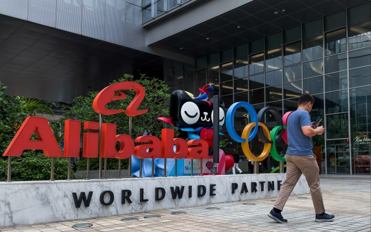 A man walks past an Alibaba display featuring the Olympic rings outside an Alibaba office building in Shenzhen, Guangdong province, on Tuesday. Photo: Getty Images