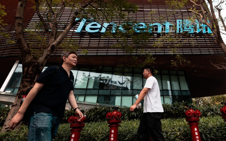People walk in front of the Tencent headquarters building in Shenzhen. Photo: EPA