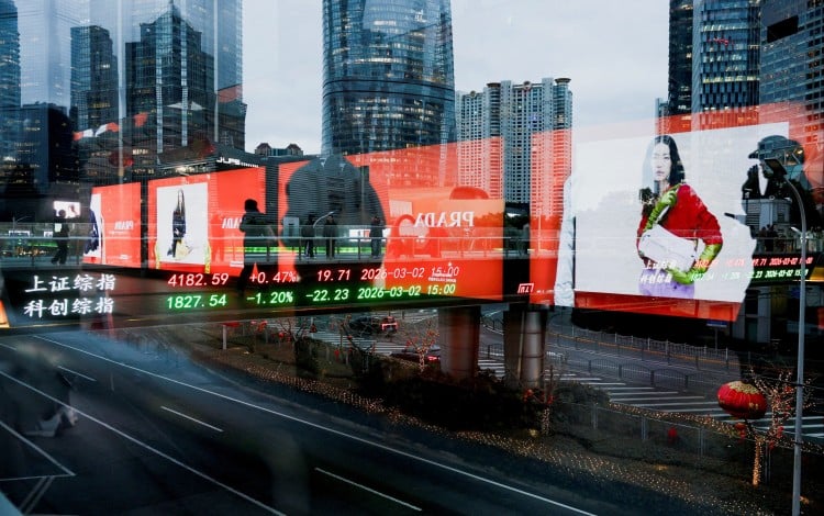Stock data is reflected on glass panels in Shanghai\'s Lujiazui financial district. Photo: Reuters
