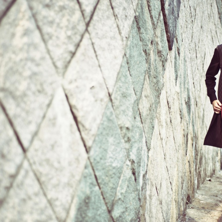 Knitted turtleneck top (HK$5,600),shirt (HK$4,800), striped long coatwith belt (HK$14,300) and striped trousers (HK$7,600), all by Prada.Wide brimmed hat (HK$2,700) by Giorgio Armani. Leather boots by Dior Homme (inquiries 2524 8277). Leather bag (HK$12,000) by Emporio Armani.