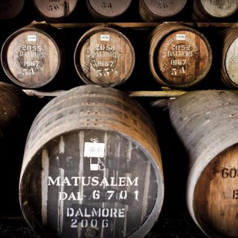 Barrels at The Dalmore distillery in Scotland (above) and its master distiller Richard Paterson (below right).