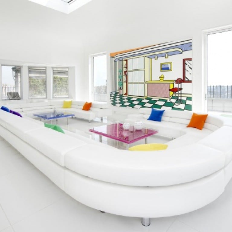 In the living room, the maxi white leather couch is juxtaposed with the bright and vivid colours of Rauschenberg and Lichtenstein paintings on the wall.