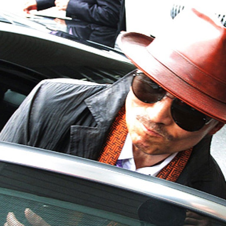 Japan woman sues yakuza boss Kenichi Shinoda over protection money