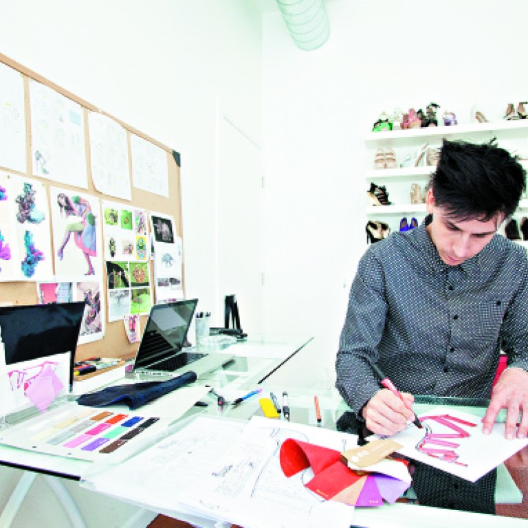 Jerome Rousseau working on one of his designs. He says his love of design took shape when he was in his teens after watching a music video of the Deee-Lite and was fascinated with their funky footwear.