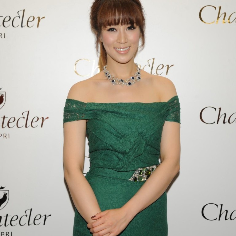 Cathy Chui was dolled up in emerald Burberry that matched her jewels