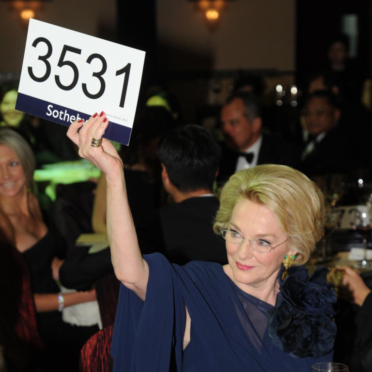 It’s a bidding war! Marguerite Lee is happy to help charity as she holds her hand up high