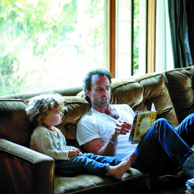 Goggins relishes the luxury of relaxing and reading to his son. Photography Martin Lof / Living Inside