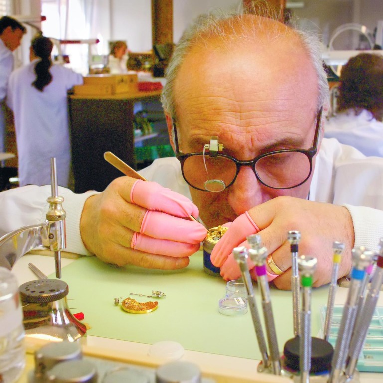 A Breguet craftsman concentrates on his complex work.