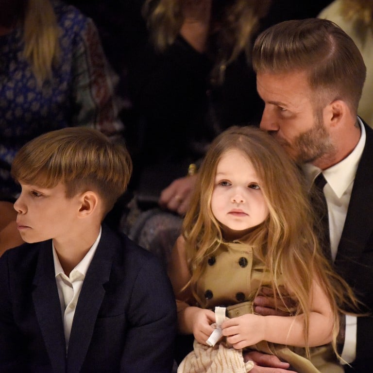 David, Romeo and Harper Beckham on the front row of Burberry London in Los Angeles show.