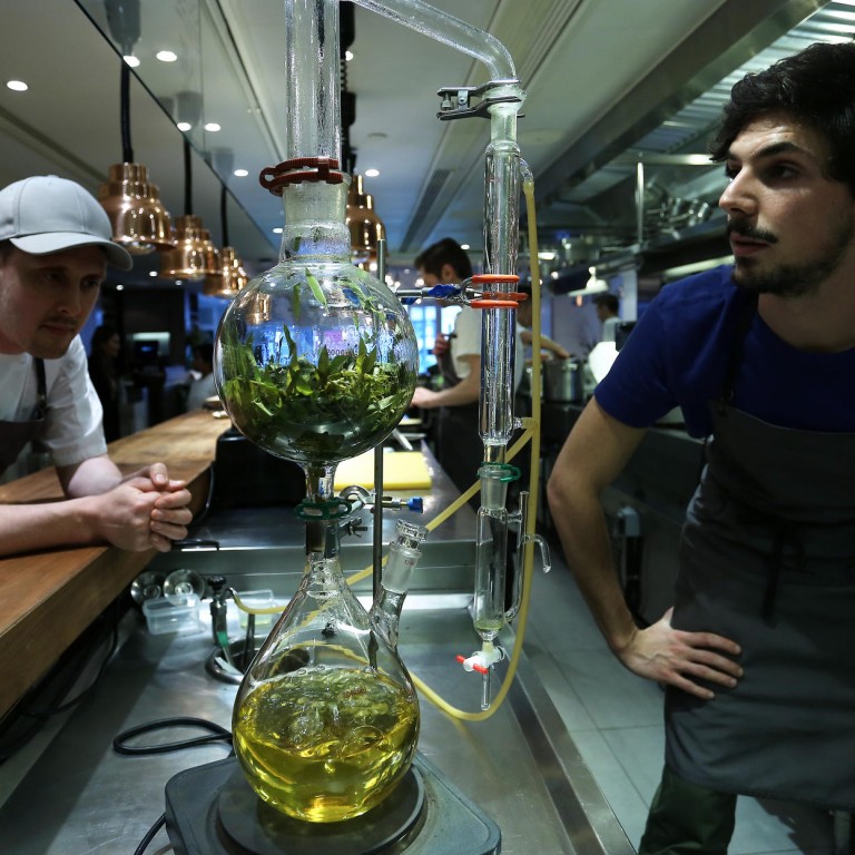 Founder and chef Nurdin Topham (left) and engineer in life sciences and technology Martin Vogel work on their steam distillation equipment for essential oils at NUR restaurant in Central. Photo: Jonathan Wong