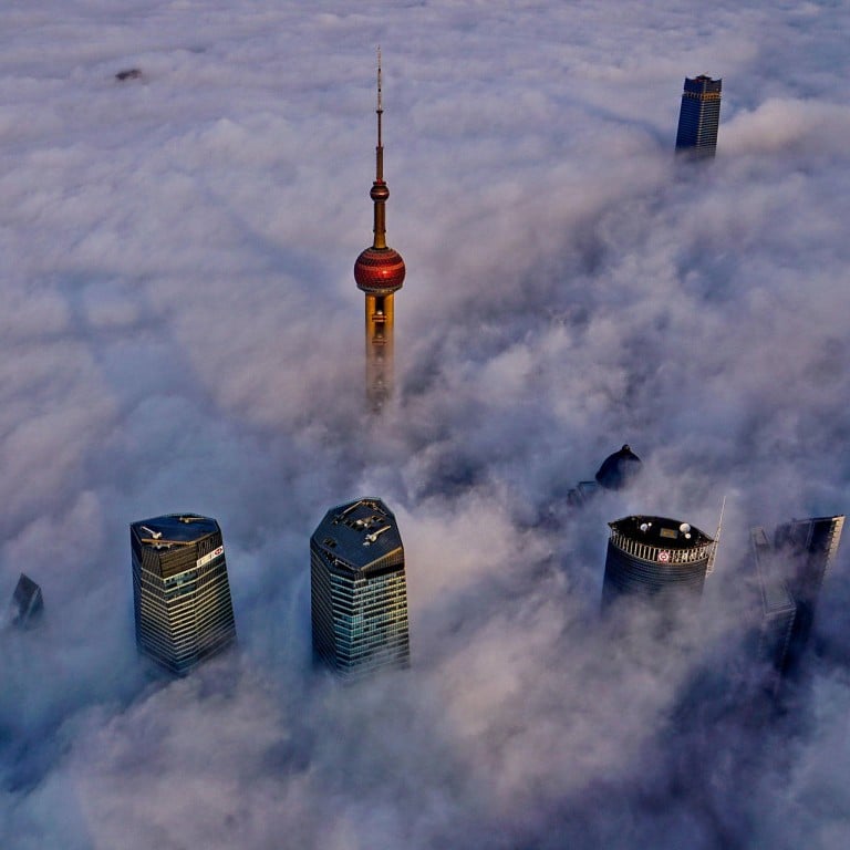 Tops of Shanghai's landmark skyscrapers, including the Oriental Pearl Tower, are seen over a sea of cloud. Opponents of tall buildings say Shanghai is like a 'monster city' because of the myriad of skyscrapers. Photo: Xinhua