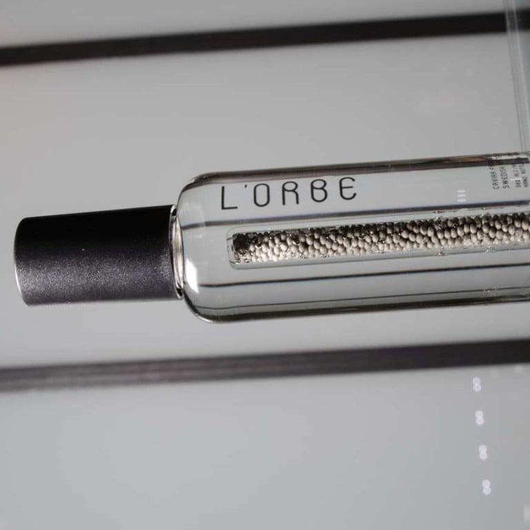 A perforated column of caviar beads sits in the center of a bottle of L'Orbe vodka inside Pernod Ricard SA's Breakthrough Innovation Group (BIG) office in Paris, France, on Friday, Feb. 24, 2017. The French distiller turned to a patented technology from the skin-care industry, allowing it to safely place caviar coated with an aqueous film into the bottle, infusing it with notes of butter and hazelnut. Photographer: Marlene Awaad/Bloomberg