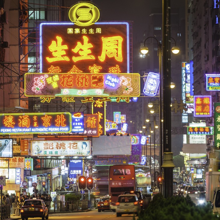 Neon signs and street lights glow above a busy night scene along Nathan Road in the crowded Tsim Sha Tsui district of Kowloon, Hong Kong. Photo: Getty Images