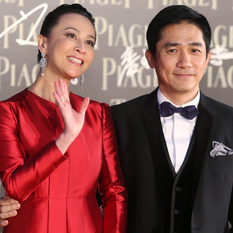 Hong Kong actress Carina Lau and her husband, actor Tony Leung Chiu-wai, posing for photographers on the red carpet of the 32nd Hong Kong Film Awards. Photo: SCMP Archives