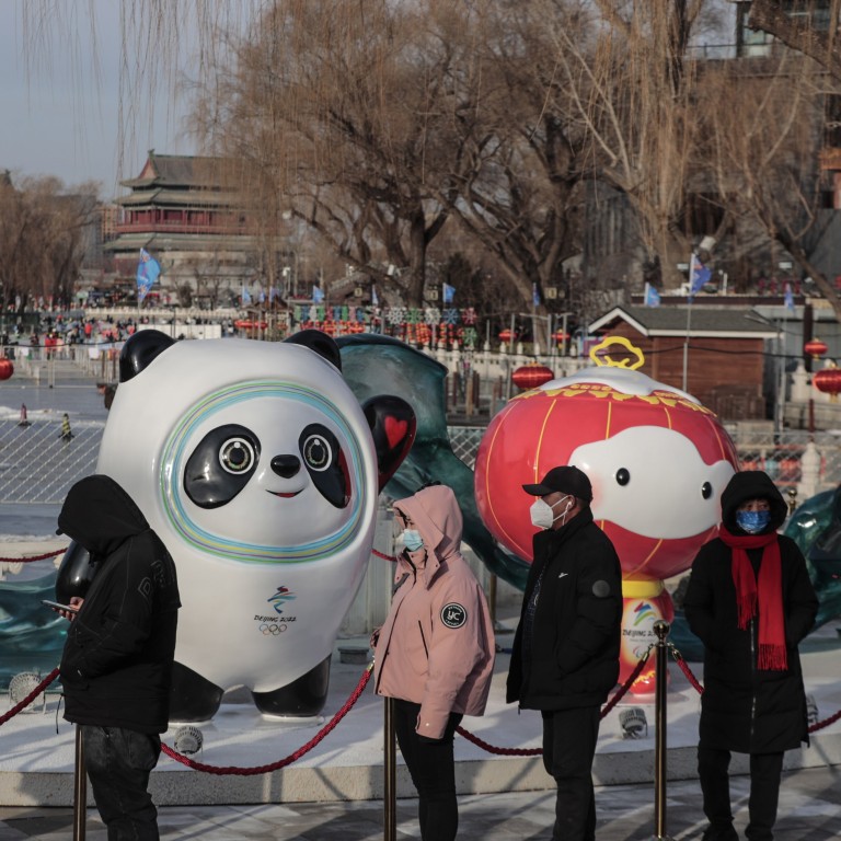 People wearing masks queue for Covid-19 nucleic acid testing near the Beijing 2022 mascots in the Chinese capital on January 26. Photo: EPA-EFE