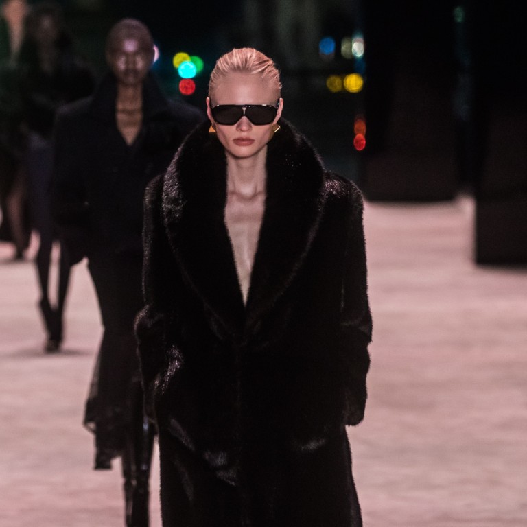 Models present creations from the autumn/winter 2022-23 women’s collection by Saint Laurent during Paris Fashion Week, on March 1, with the runway laid out at the foot of the Eiffel Tower. Photo: EPA-EFE