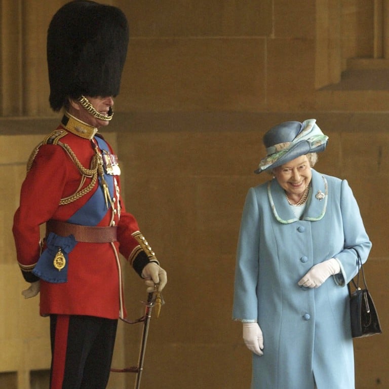 FILE - In this Tuesday April 15, 2003 file photo, Britain’s Queen Elizabeth II and Prince Philip prior to The Queen’s Company Grenadier Guards ceremonial review at Windsor Castle, Windsor, England. Buckingham Palace says Prince Philip, husband of Queen Elizabeth II, has died aged 99. (AP Photo/Chris Young, Pool, file)