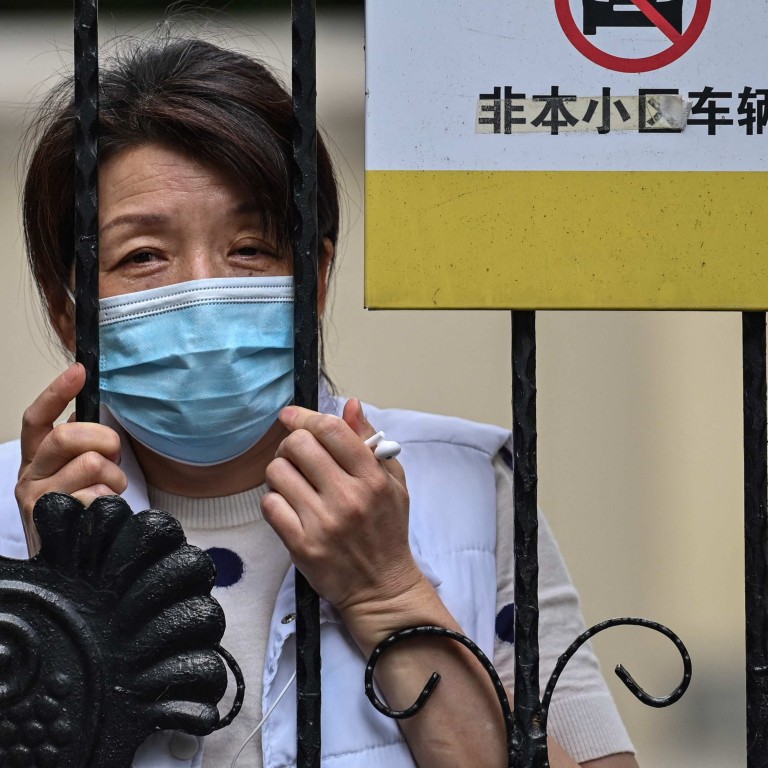 A resident locked down in her compound in the Jing’an district of Shanghai on May 25, 2022. Photo: AFP