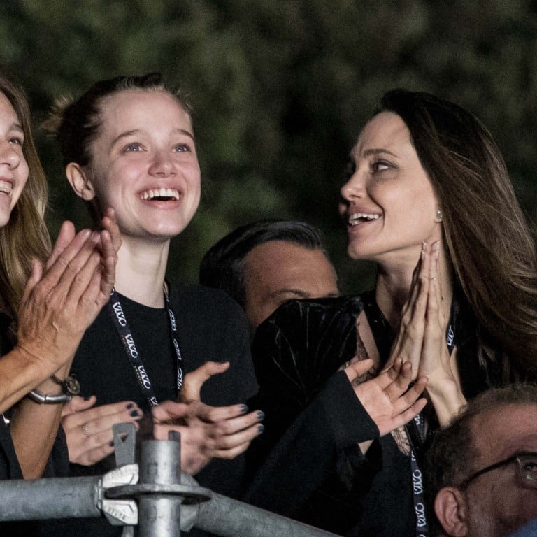 Like mother, like daughter: Angelina Jolie and daughter Shiloh Jolie-Pitt clap along to a rock concert in Italy. Photo: IPA