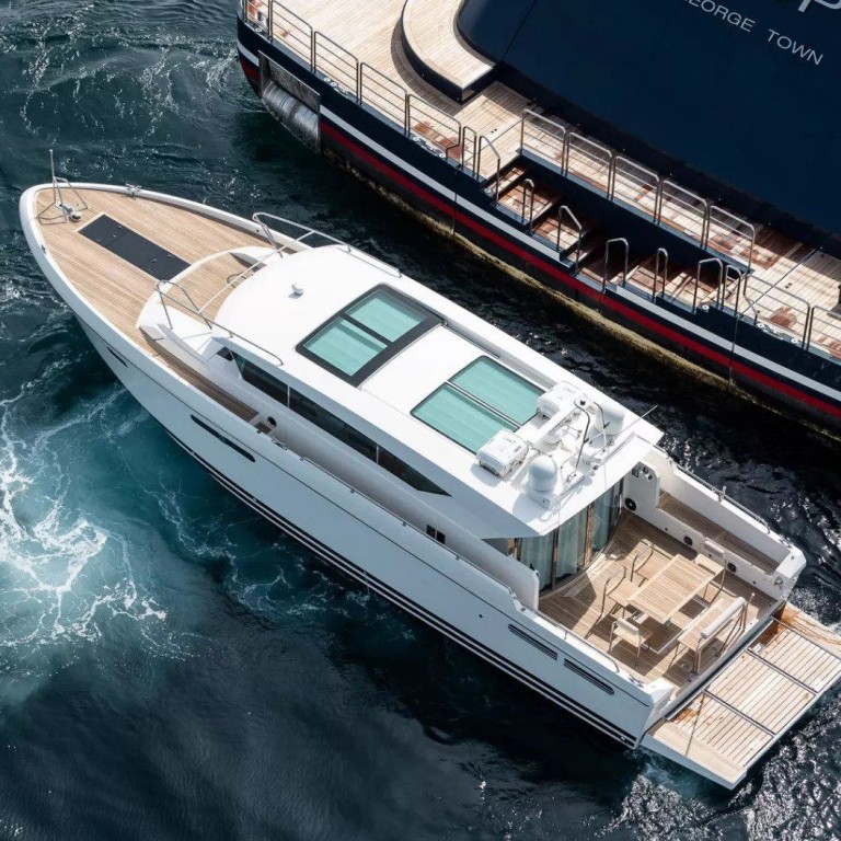 A smaller boat idles beside the 126-metre Octopus superyacht, once owned by Microsoft’s Paul Allen. Photo: Camper & Nicholsons