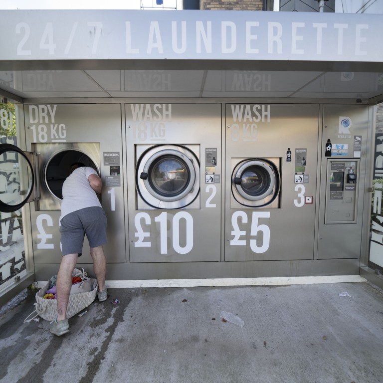 Amended prices seen at a self-service laundromat in Manchester on September 7, 2022. More than 1 million more people will be forced into poverty this winter, pushing UK deprivation levels to their highest for two decades even if the government freezes energy prices at current levels, according to media reports. Photo: AP
