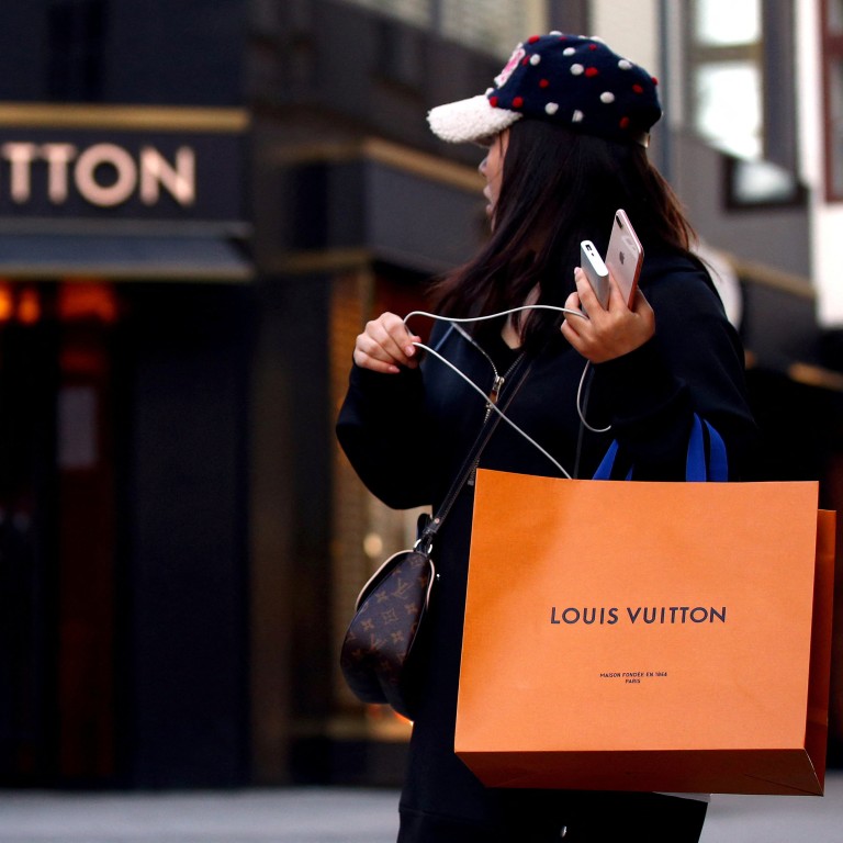 A woman with a Louis Vuitton branded shopping bag in Vienna, Austria, where sales of luxury goods are soaring for LVMH’s brands thanks to returning American tourists. Photo: Reuters