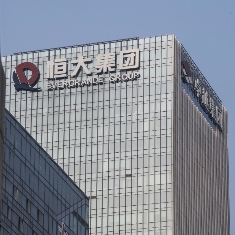 The logo of China Evergrande Group is displayed on a building in Shenzhen. The developer is reeling under US$300 billion of debt. Photo: Bloomberg