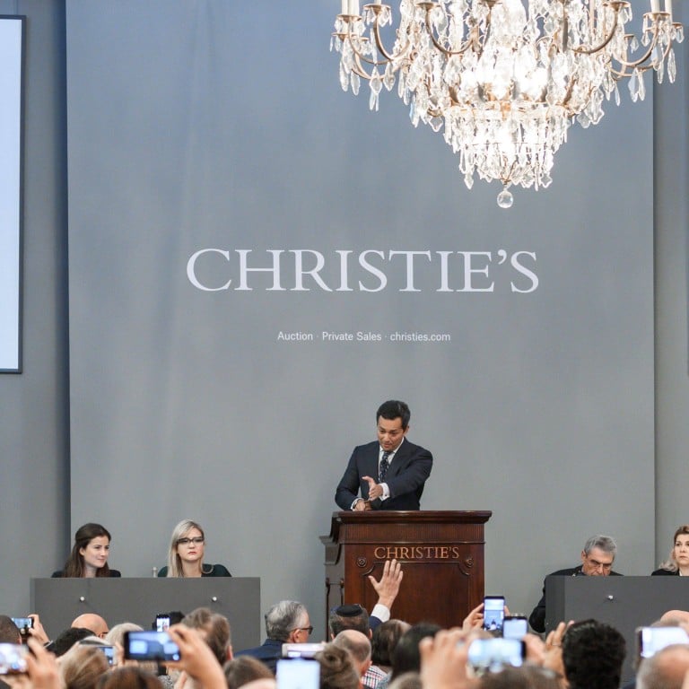 Christie’s jewellery department head Rahul Kadakia holds the hammer during the sale of The Pink Legacy, an 18.96-carat diamond once owned by the Oppenheimer family, in Geneva, in 2018. Photo: AFP